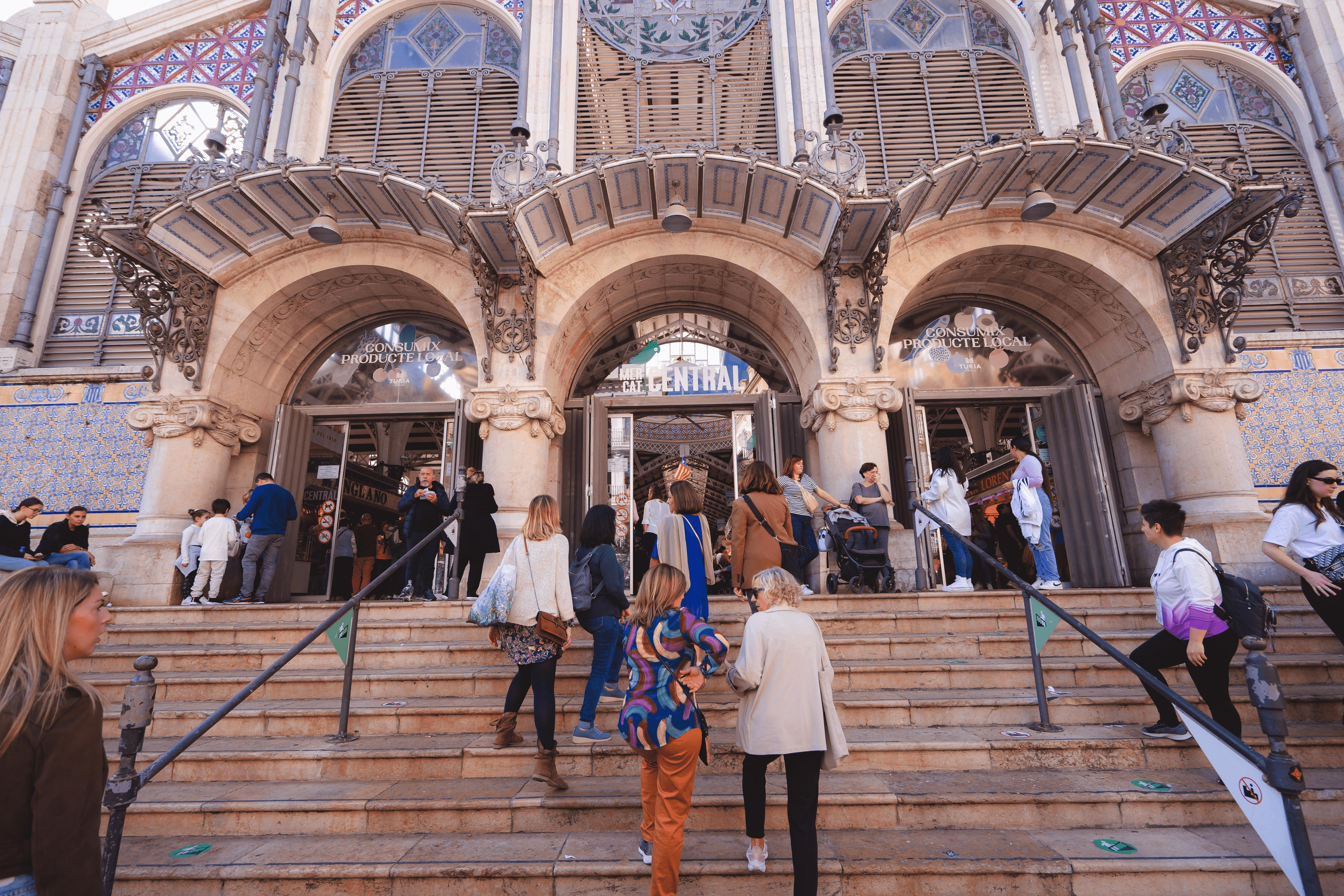 tourist group entering central market on hidden gems tour valencia